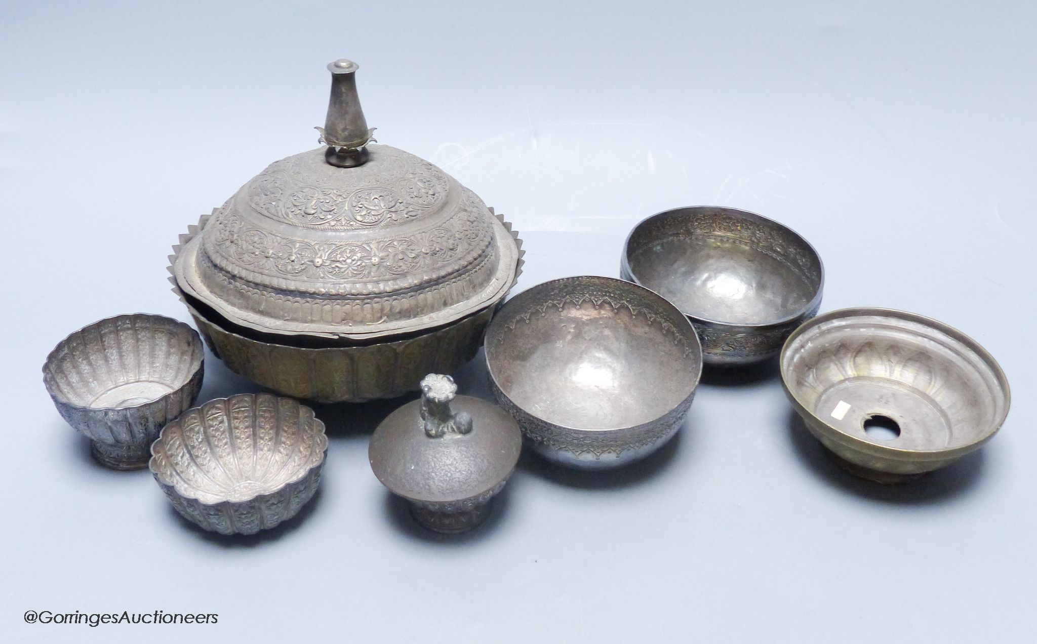 A Malay Straits pedestal bowl and cover or 'Batil Ber Tutop' (a.f.), three Malay Straits white metal betel nut cups and two similar small bowls